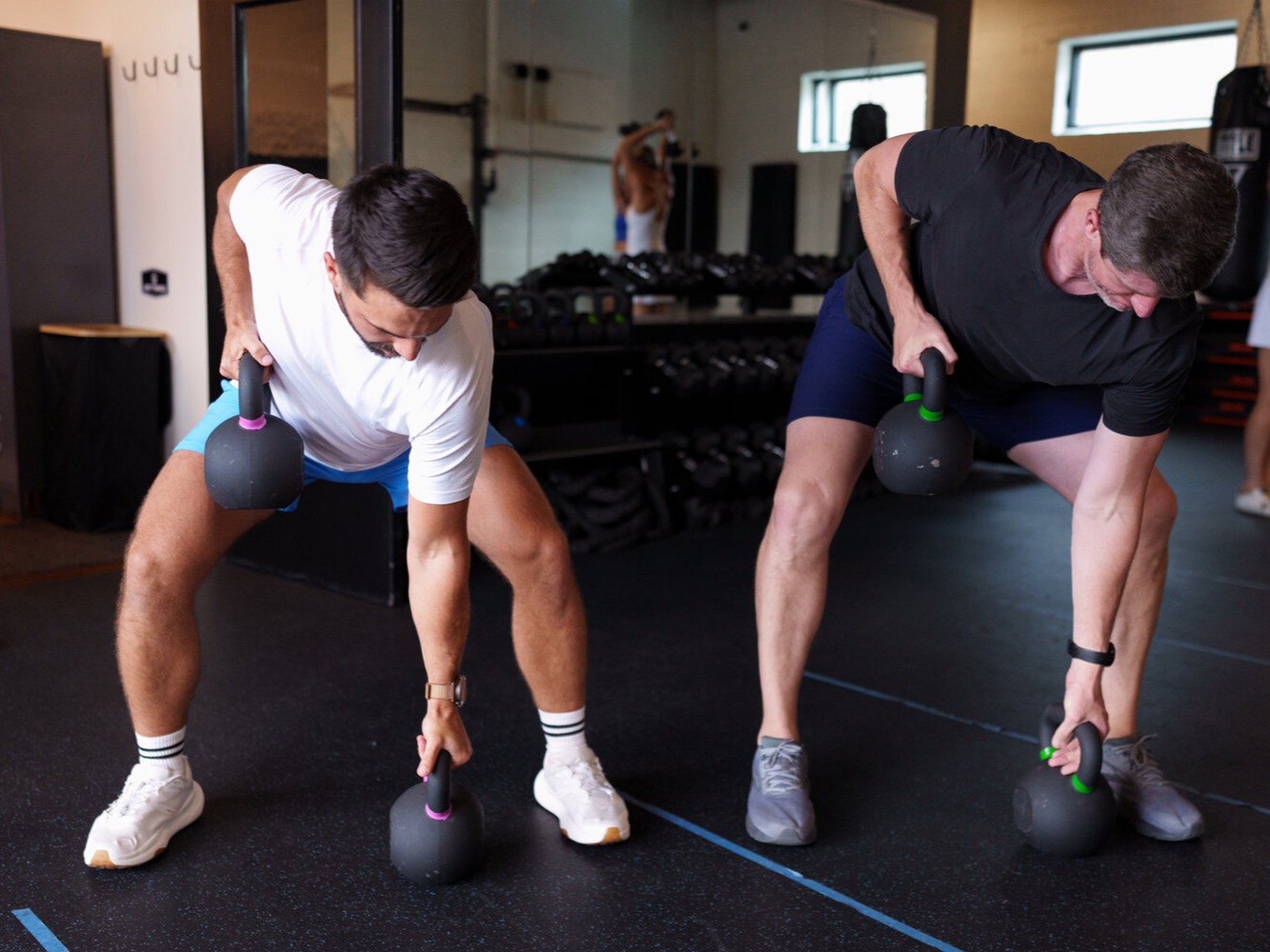 Members doing kettlebell rows during a Strength class at SWC